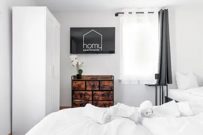 Ein Bett oder Betten in einem Zimmer der Unterkunft homy Lakeside Symphony in Bregenz am Bodensee