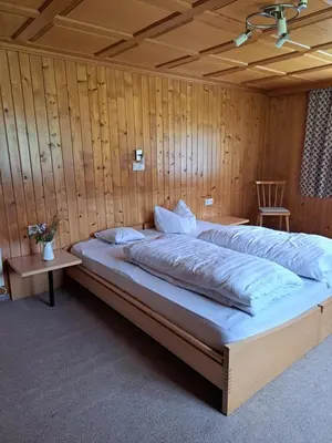 Ein Bett oder Betten in einem Zimmer der Unterkunft Familienfreundliches Bregenzerwälderhaus