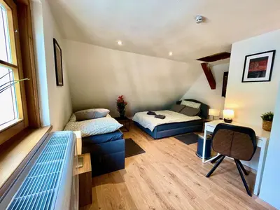 Ein Bett oder Betten in einem Zimmer der Unterkunft Lake Family and Group Apartments