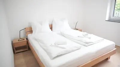 Ein Bett oder Betten in einem Zimmer der Unterkunft Rosengarten Apartments