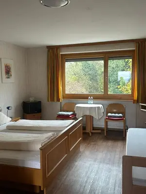 Ein Bett oder Betten in einem Zimmer der Unterkunft Pension Tsingdao