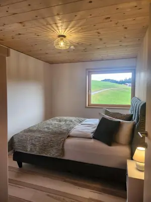 Ein Bett oder Betten in einem Zimmer der Unterkunft Blickfang Bregenzerwald