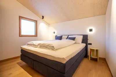 Ein Bett oder Betten in einem Zimmer der Unterkunft Modernes Architektur-Chalet mit Alpenpanorama