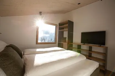 Ein Bett oder Betten in einem Zimmer der Unterkunft Modernes Architektur-Chalet mit Alpenpanorama