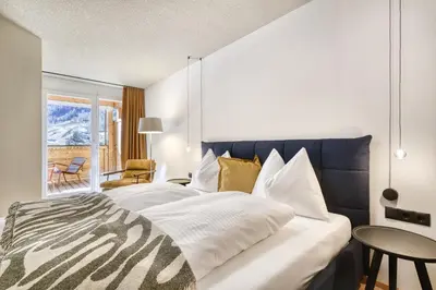 Ein Bett oder Betten in einem Zimmer der Unterkunft Panorama Deluxe by Hotel Lün