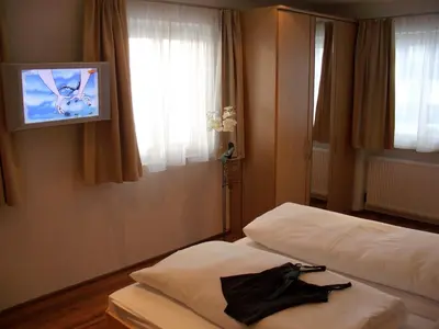 Ein Bett oder Betten in einem Zimmer der Unterkunft Hotel Stülzis