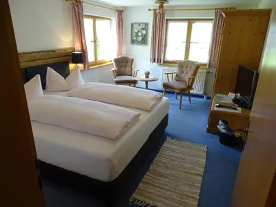 Ein Bett oder Betten in einem Zimmer der Unterkunft Der Berghof