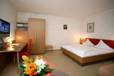 Ein Bett oder Betten in einem Zimmer der Unterkunft Hotel Bischof