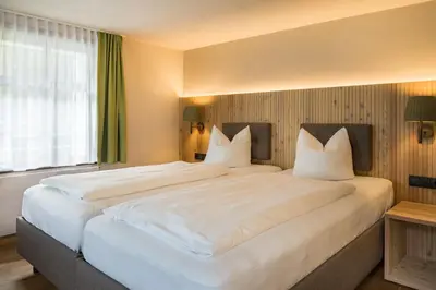 Ein Bett oder Betten in einem Zimmer der Unterkunft Hotel Sonne