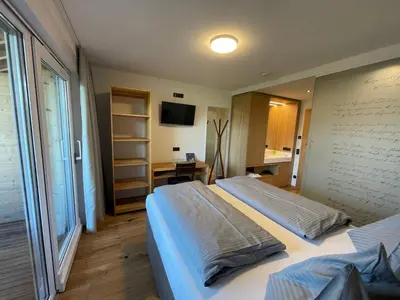 Ein Bett oder Betten in einem Zimmer der Unterkunft Panoramahotel Sonnhalde