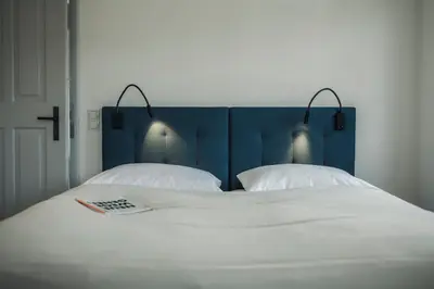 Ein Bett oder Betten in einem Zimmer der Unterkunft Krone Hard - self check-in