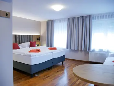 Ein Bett oder Betten in einem Zimmer der Unterkunft Hotel Linde-Sinohaus