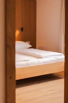 Ein Bett oder Betten in einem Zimmer der Unterkunft Aparthotel Hubertus Mellau