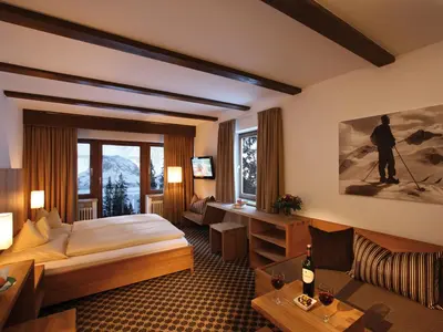 Ein Bett oder Betten in einem Zimmer der Unterkunft Cresta.Alpin.Sport.Hotel
