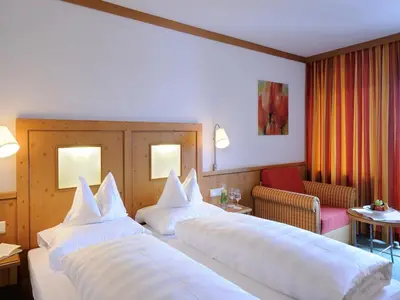 Ein Bett oder Betten in einem Zimmer der Unterkunft Cresta.Alpin.Sport.Hotel
