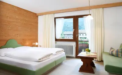 Ein Bett oder Betten in einem Zimmer der Unterkunft Haus Arnika