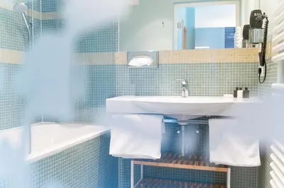Ein Badezimmer in der Unterkunft Alpinikum Apartments