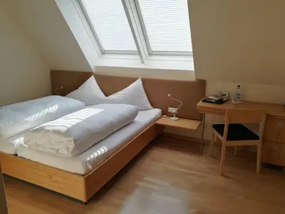 Ein Bett oder Betten in einem Zimmer der Unterkunft Der Löwen, Löwen Betriebs- und Management GmbH