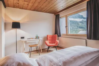 Ein Bett oder Betten in einem Zimmer der Unterkunft BOUTIQUEHOTEL das edelweiss