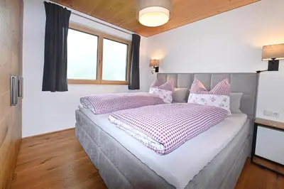 Ein Bett oder Betten in einem Zimmer der Unterkunft Panoramahof Bergglück