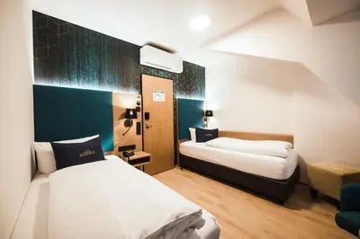 Ein Bett oder Betten in einem Zimmer der Unterkunft Hotel Messmer