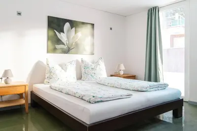 Ein Bett oder Betten in einem Zimmer der Unterkunft Rosa - Huusa im Bregenzerwald
