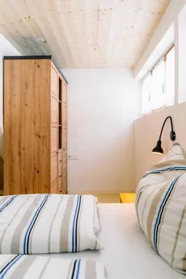 Ein Bett oder Betten in einem Zimmer der Unterkunft Hugo - der Bodenständige - Huusa im Bregenzerwald