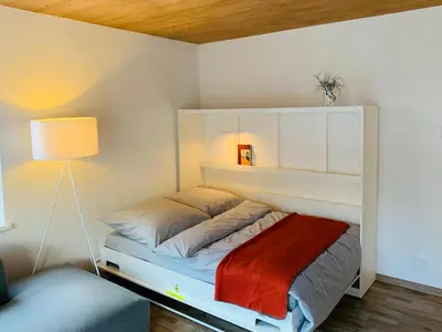 Ein Bett oder Betten in einem Zimmer der Unterkunft Dorf(er)leben Ferienwohnung im Kleinwalsertal