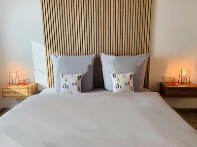 Ein Bett oder Betten in einem Zimmer der Unterkunft Dorf(er)leben Ferienwohnung im Kleinwalsertal